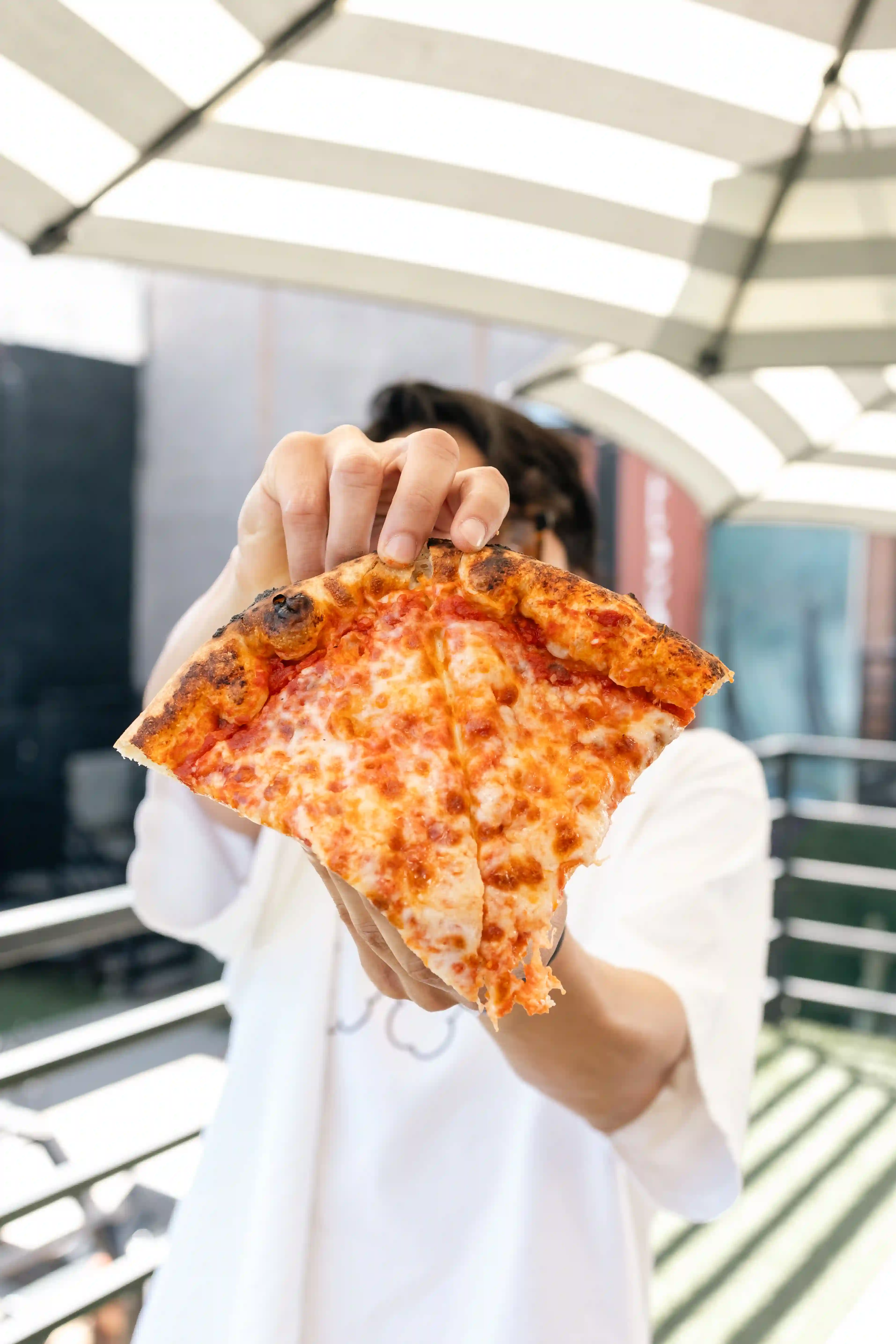 man with slice of pizza